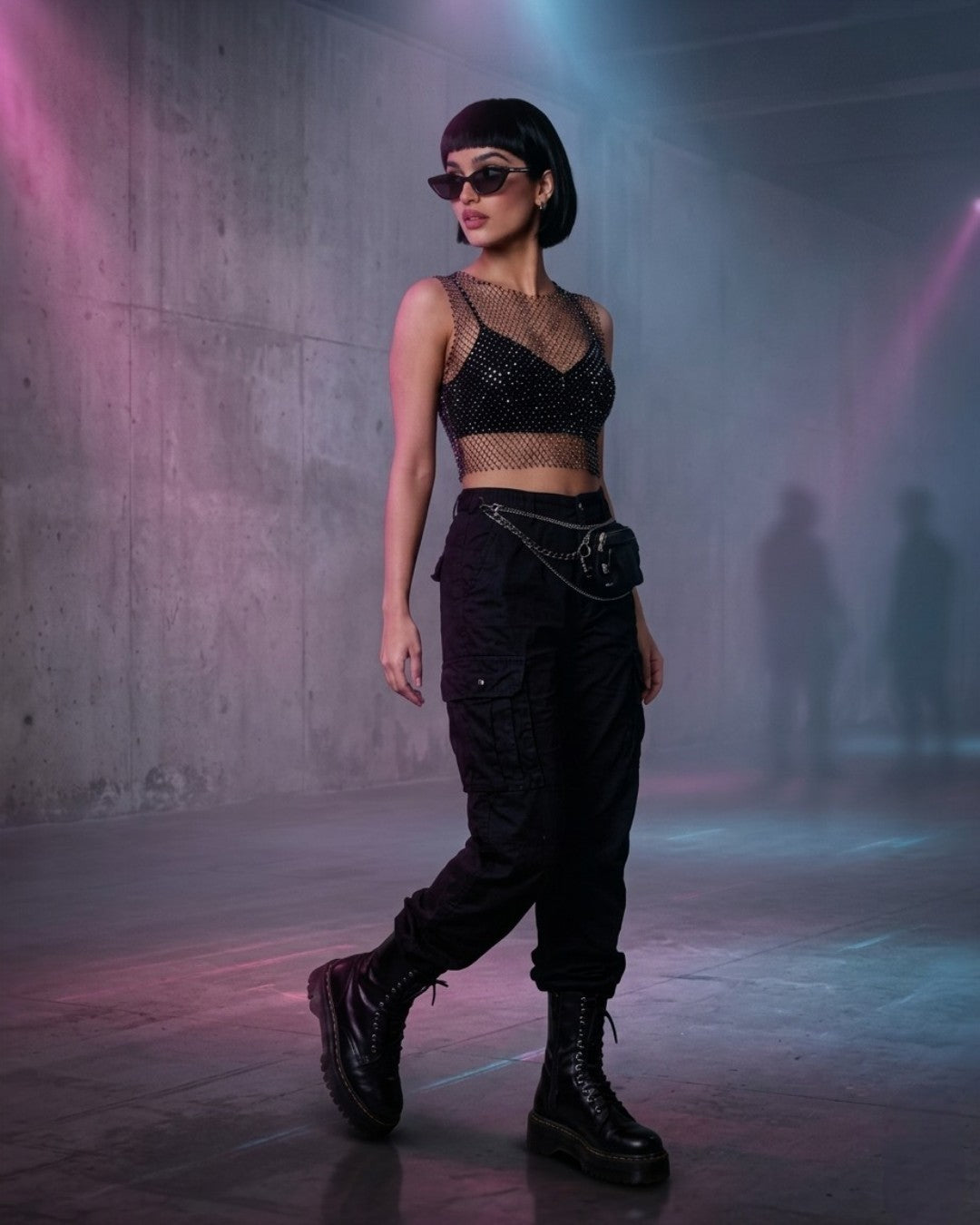 Woman wearing a FlexyDrip black rhinestone mesh top with sunglasses in an underground rave party.